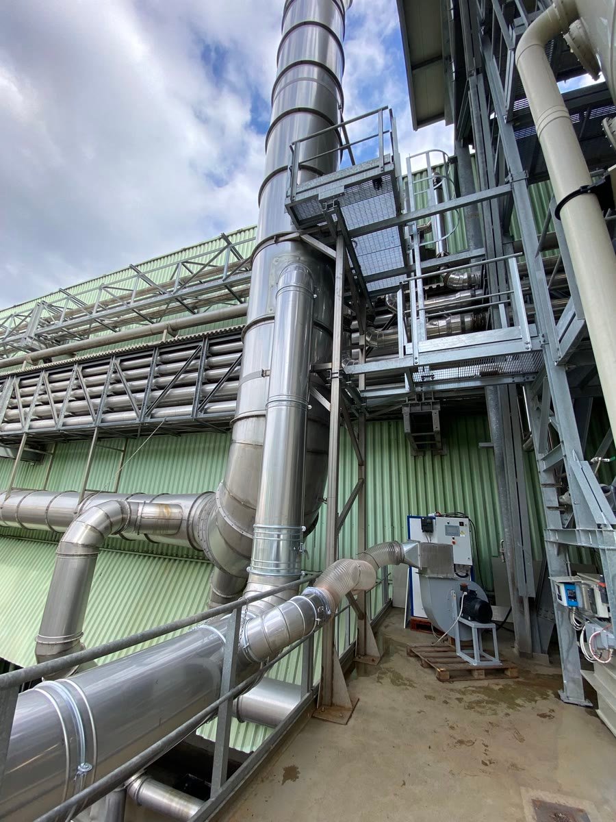Stainless process ductwork and a PURA unit with its blower on an installation site