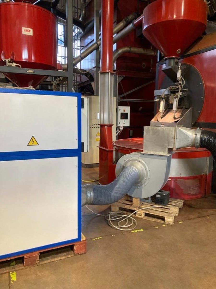 A PURA cabinet on a pallet, its fan and flexible duct connected to a process line