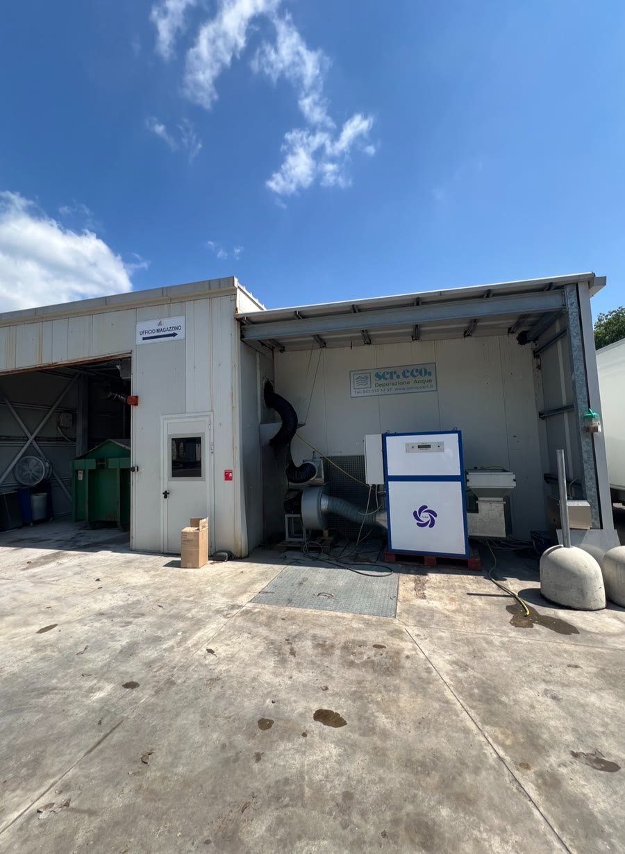 A PURA cabinet installed under an open-sided shelter outside a plant building