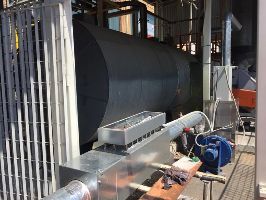 A galvanised manifold and a blower mounted on a large process duct