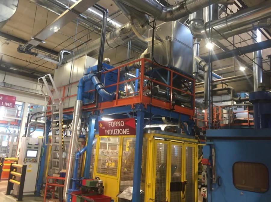 An induction furnace with its extraction ductwork overhead